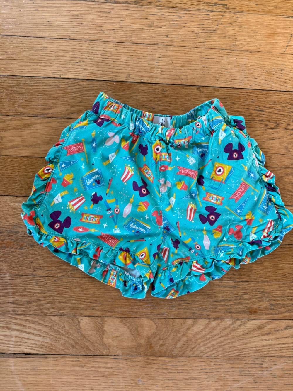 Disney Turquoise Ruffled Shorts with Carnival Print